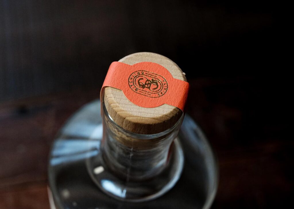 Top of a bottle of Ditchling gin showing the wooden cork and red paper label