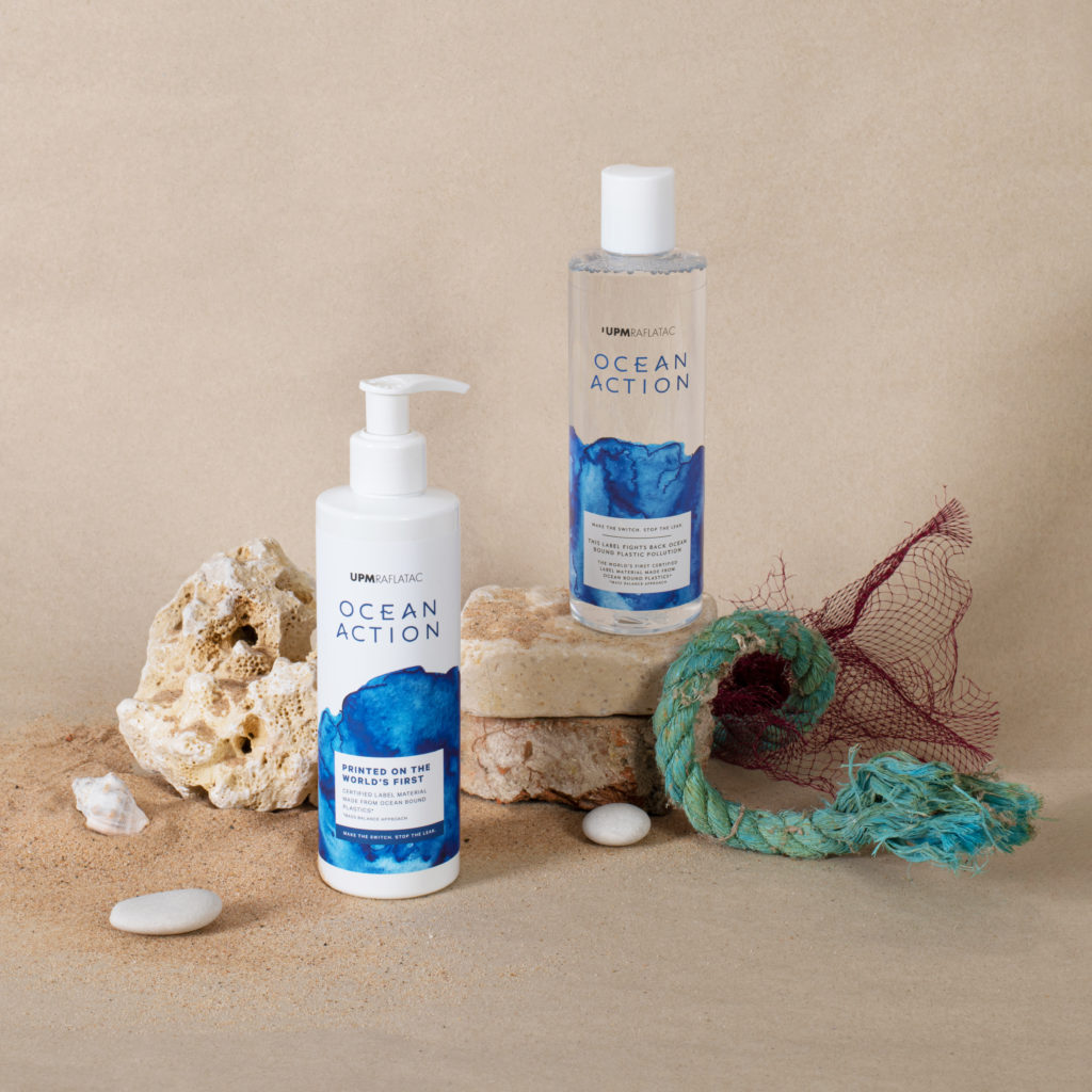 UPM Ocean Action bottles styled among reclaimed objects such as rocks, rope, plastic bags and sand