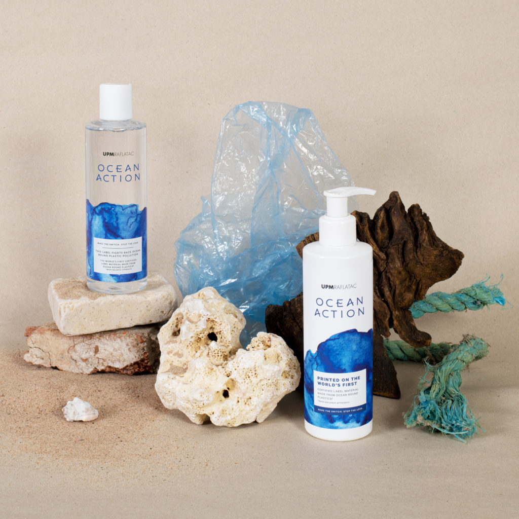 UPM Ocean Action bottles styled among reclaimed objects such as rocks, rope, plastic bags and sand